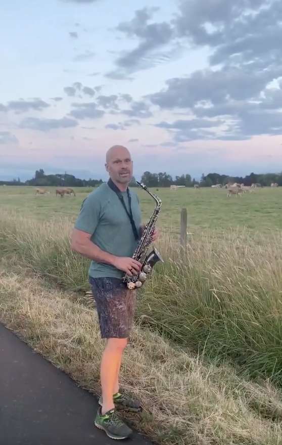 Man takes saxophone 