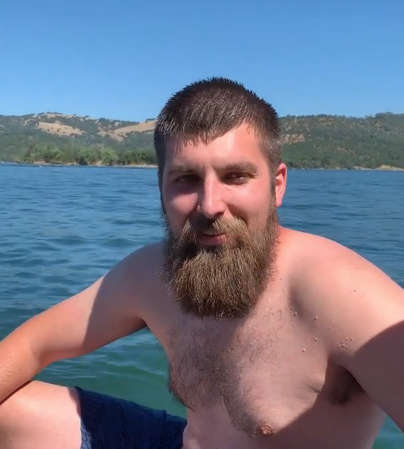 A brave man jumps in a lake to save life of a drowning baby deer
