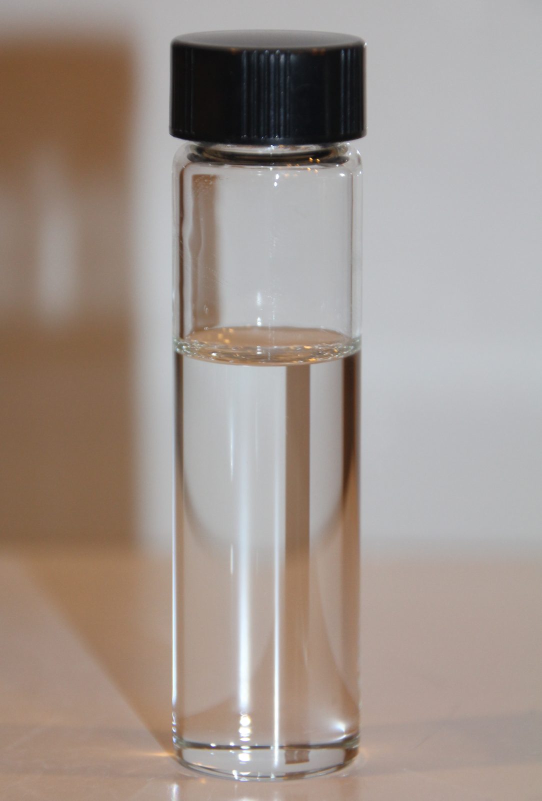 Small glass vial of clear ethylene glycol, the ingredient that makes antifreeze deadly