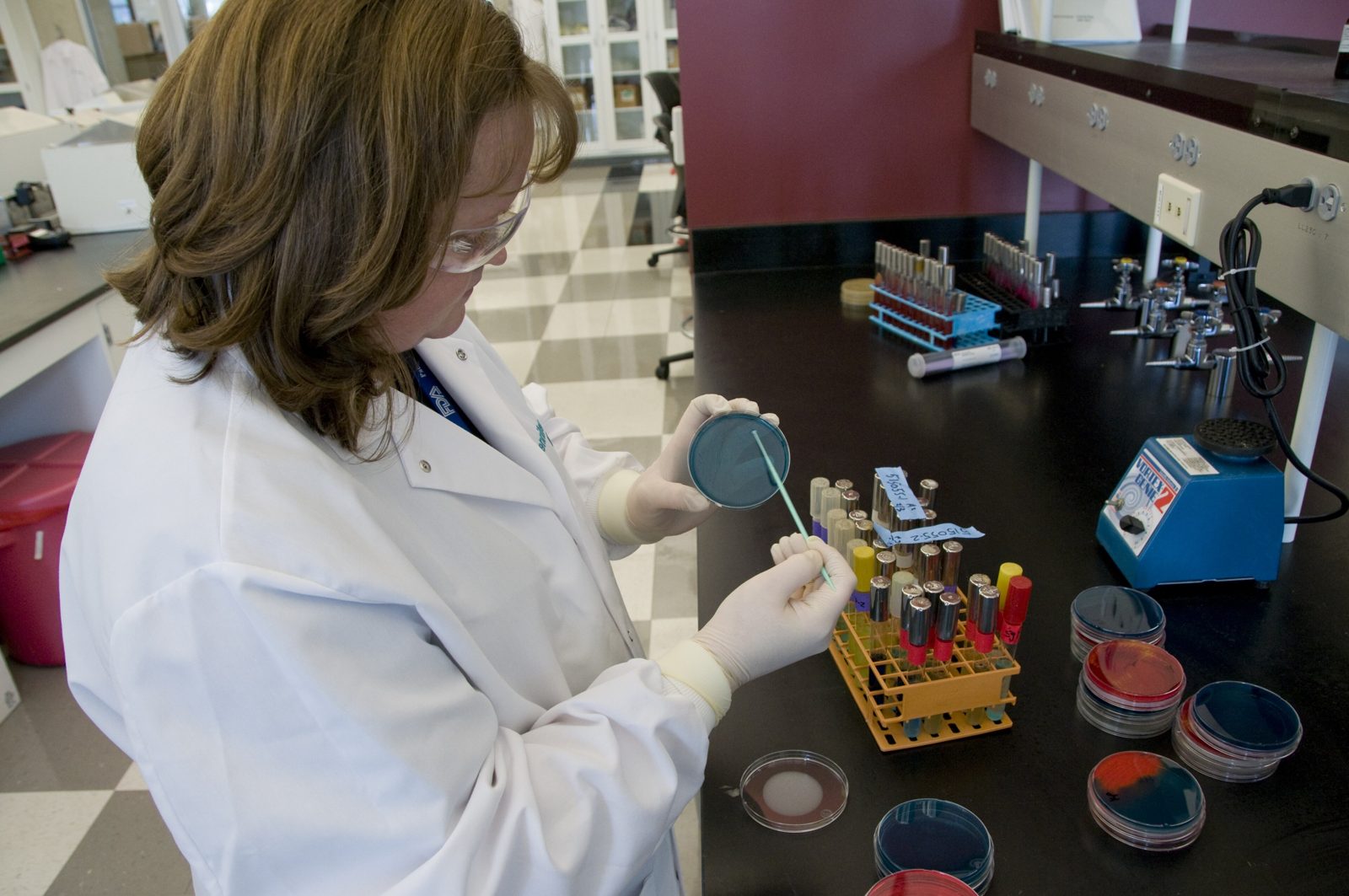 FDA laboratory technician handling culture plates during food testing