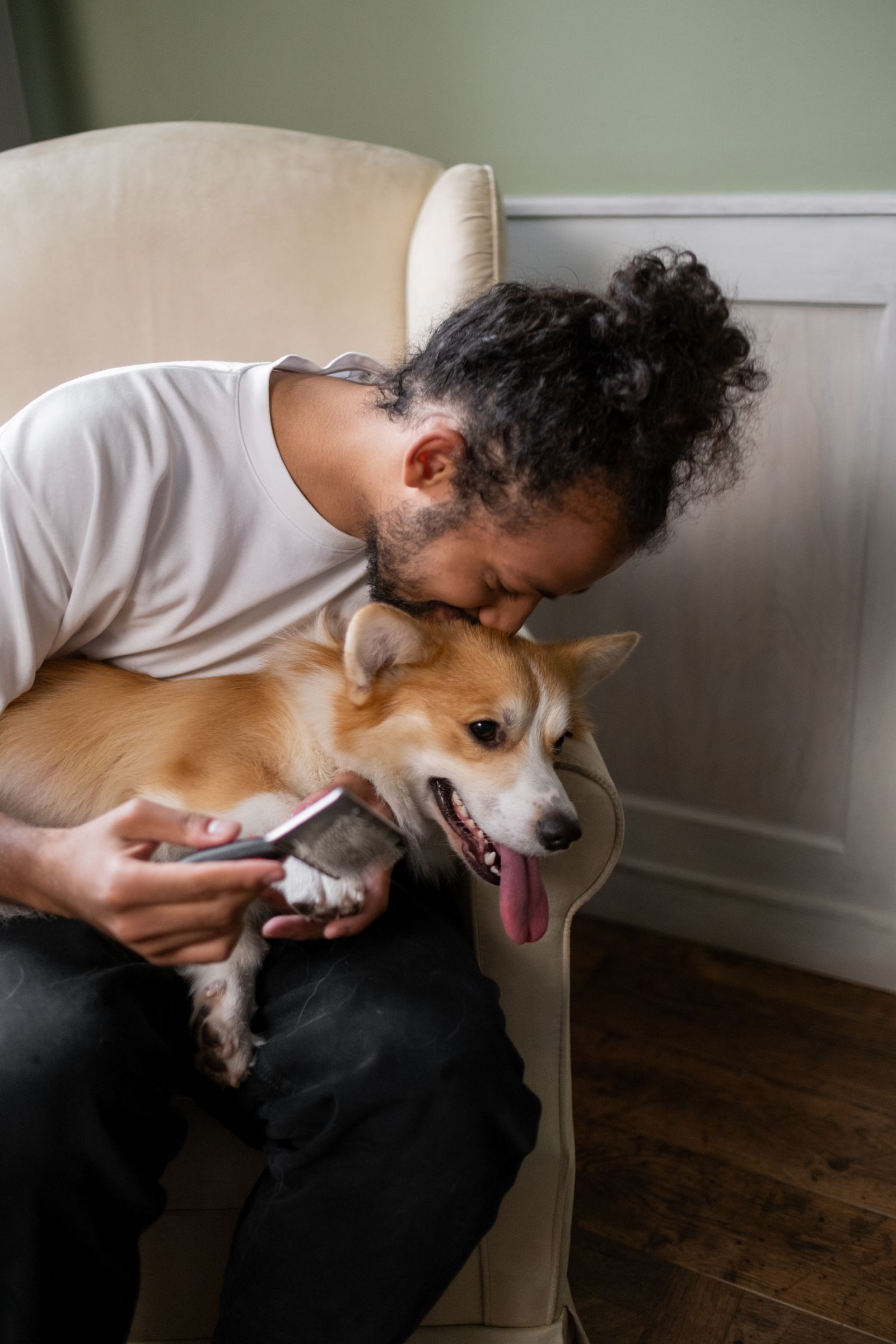 A man holding his dog close to his face